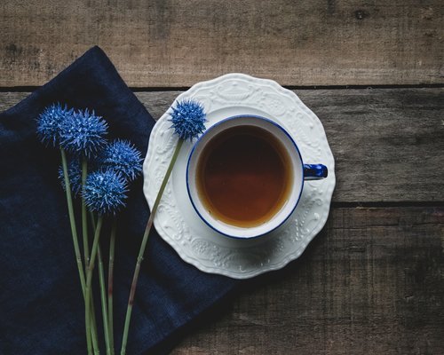 Calm morning routine with a cup of tea on a wooden table